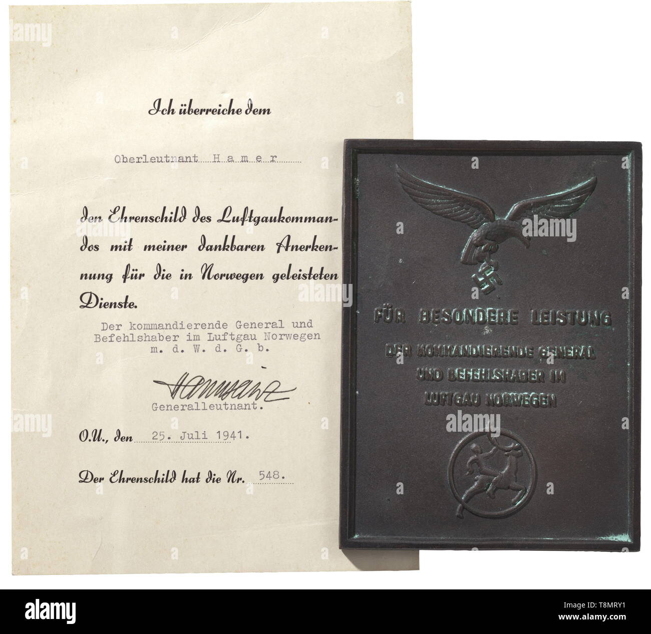An honour plaque for Special Achievement in Air District Norway - Knight's Cross winner Reino Hamer Award document (no. 548) for the plaque awarded on 25 July 1941 to Oberleutnant Hamer with original signature of the commanding general. Included is the plaque, with reverse frame assembly, number and Oslo maker's mark. The document and the plaque with matching numbers. Document dimensions 15 x 21 cm, plaque dimensions 11 x 15 cm. Reino Hamer was awarded the Knight's Cross of the Iron Cross on 5 September 1944 as a Hauptmann (captain) while in command of I./Fallschirm-Jäger R, Editorial-Use-Only Stock Photo