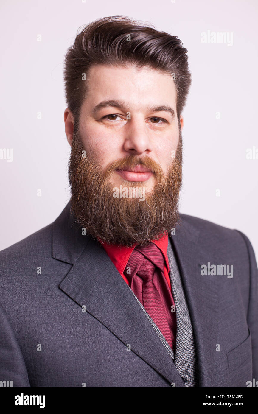 Elegant bearded man with stylish beard over white background. Male portrait. Casual styling. Stock Photo