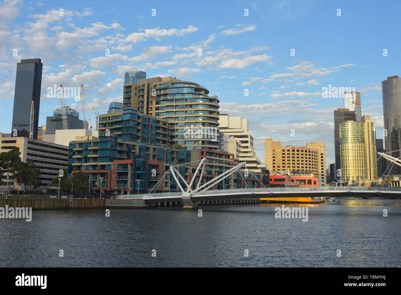 Distant view of Seafarers Bridge over Yarra River with modern buildings of Northbank in background. Stock Photo
