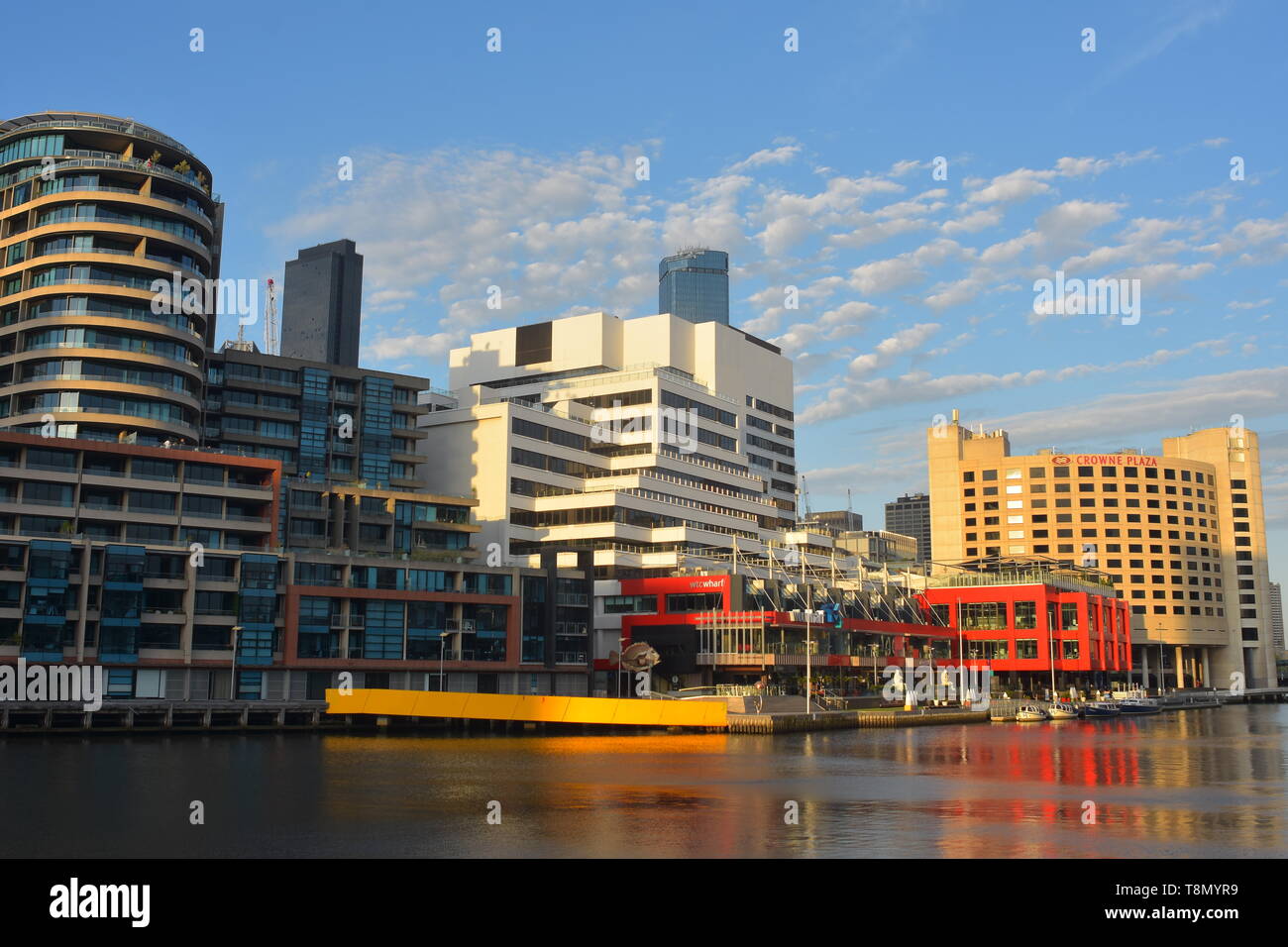 View of northern bank of Yarra River in Melbourne with modern buildings in vivid colors during golden hour. Stock Photo