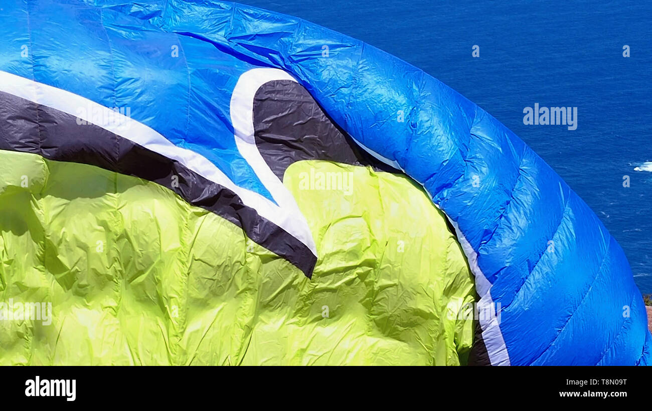 big inflated sail of a paraglider just before departure in the colors yellow and blue Stock Photo