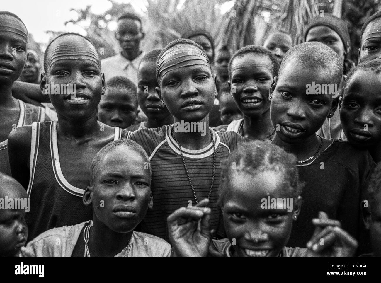 Young Dinka men and children, Malual Kon, south Sudan Stock Photo