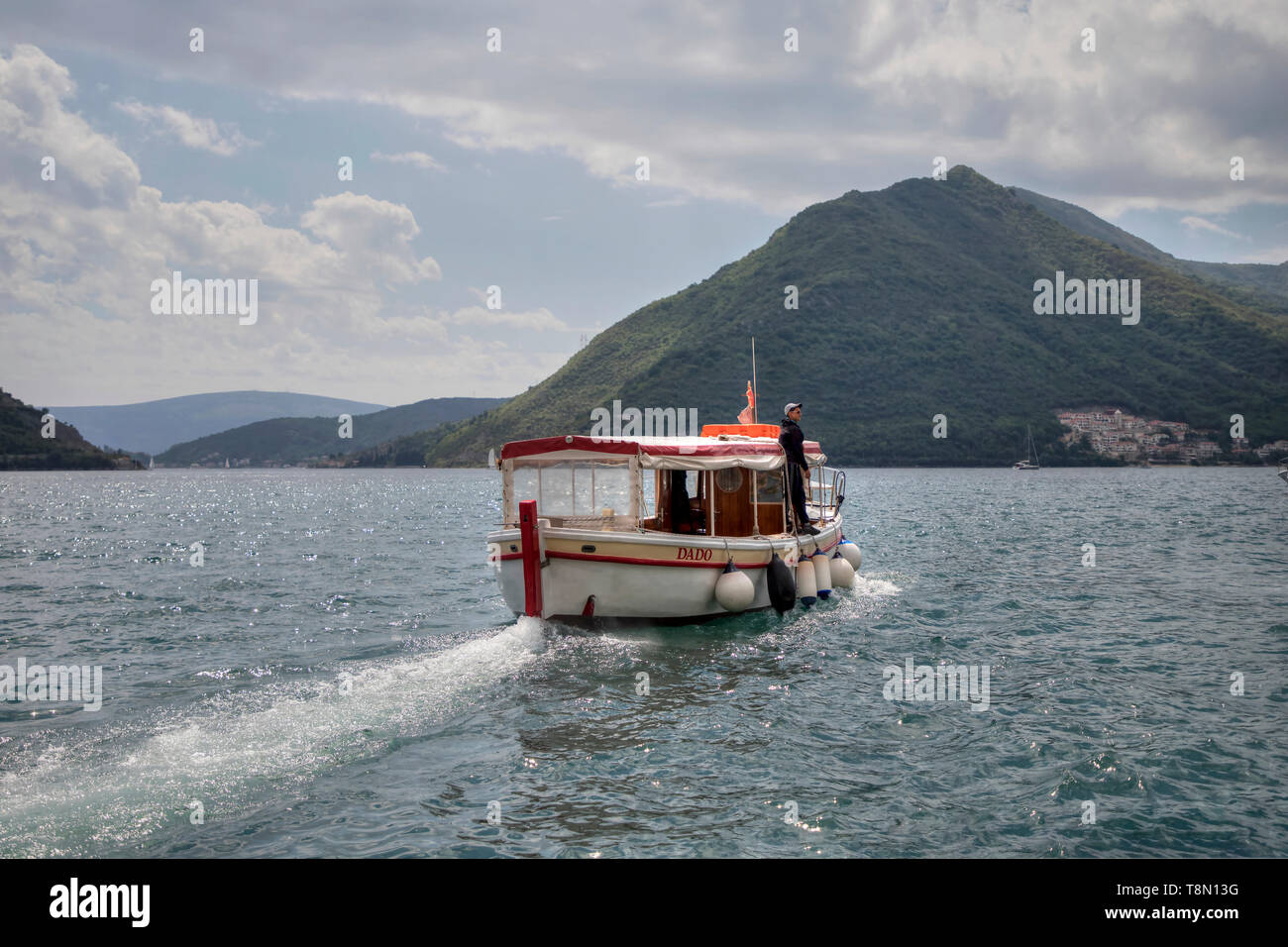 Kotor Bay, Montenegro, May 3rd 2019: A boat moving away after disembark the passengers in the ancient town of Perast Stock Photo