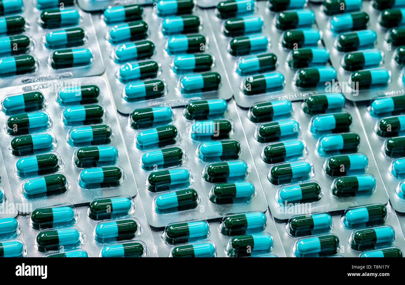 Amoxicillin capsule in blister pack. Pharmaceutical industry. Green