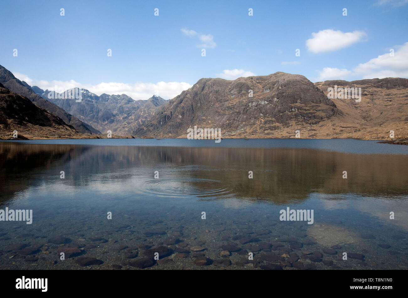 Remote Loch Coruisk reflecting back the Black Cullin mountain range on the Isle of Skye in the Scottish Highlands. Accessed by boat from Elgol. Stock Photo