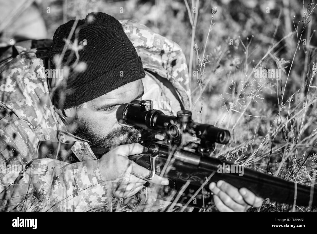 Hunting skills and weapon equipment. How turn hunting into hobby. Bearded man hunter. Army forces. Camouflage. Military uniform fashion. Man hunter with rifle gun. Boot camp. Army soldiers. Stock Photo