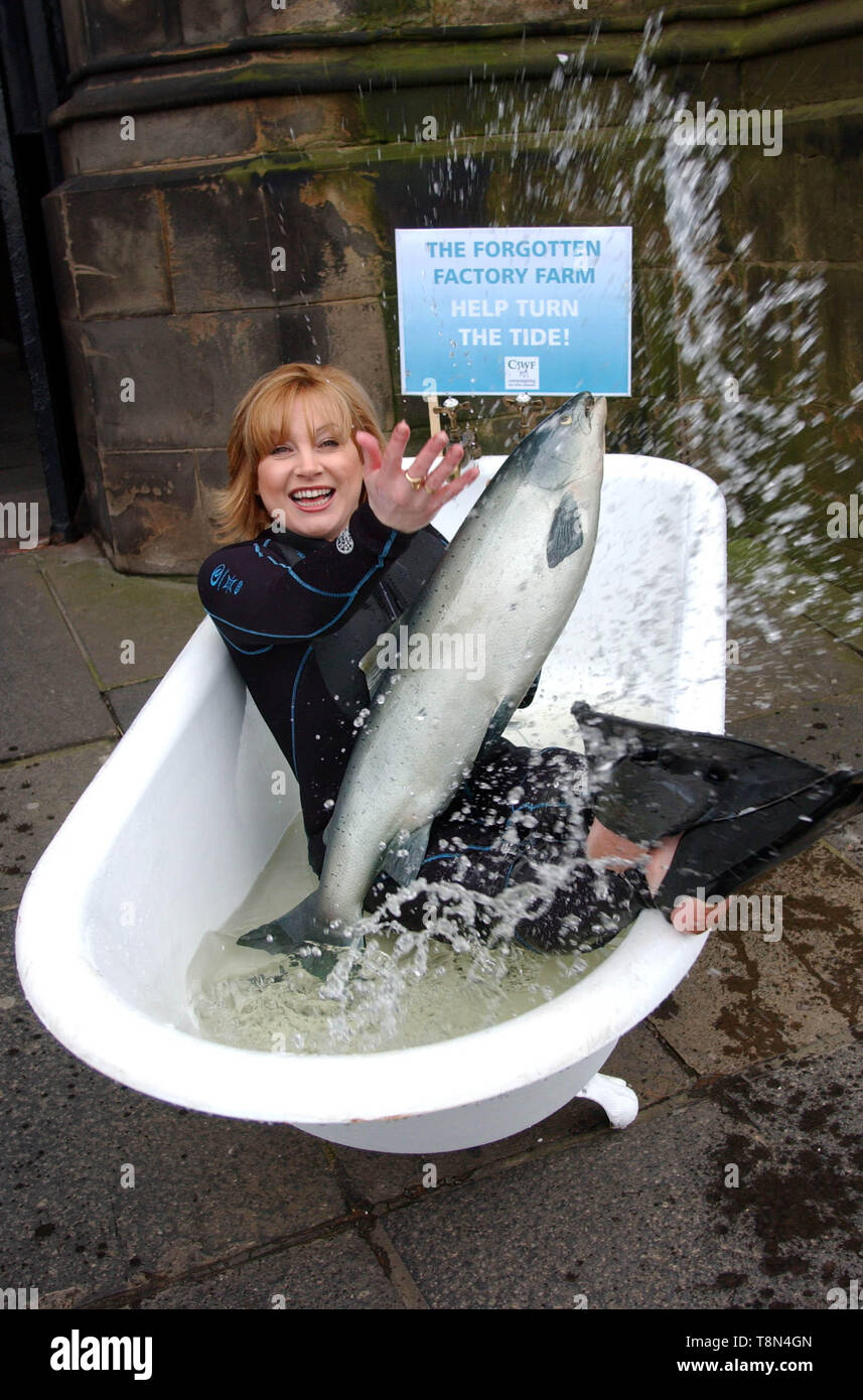 Celebrity TV presenter Wendy Turner ( Pet Rescue & Absolutely Animals, sister of Anthea Turner ) sits in a bath of cold water along with a life size model salmon outside The Scottish Parliament in Edinburgh today ( Thursday 31/1/02 ) to highlight research that brings attention to the plight of factory farmed fish which the research claims can be crammed into cages of 50,000 with each fish having only the equivalent of one bath of water to itself. Stock Photo
