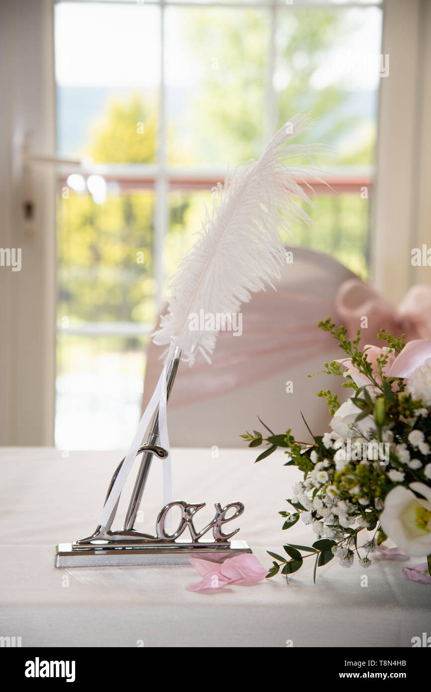 The solemn registration of marriage: the fountain pen quill in a holder with the words love Stock Photo