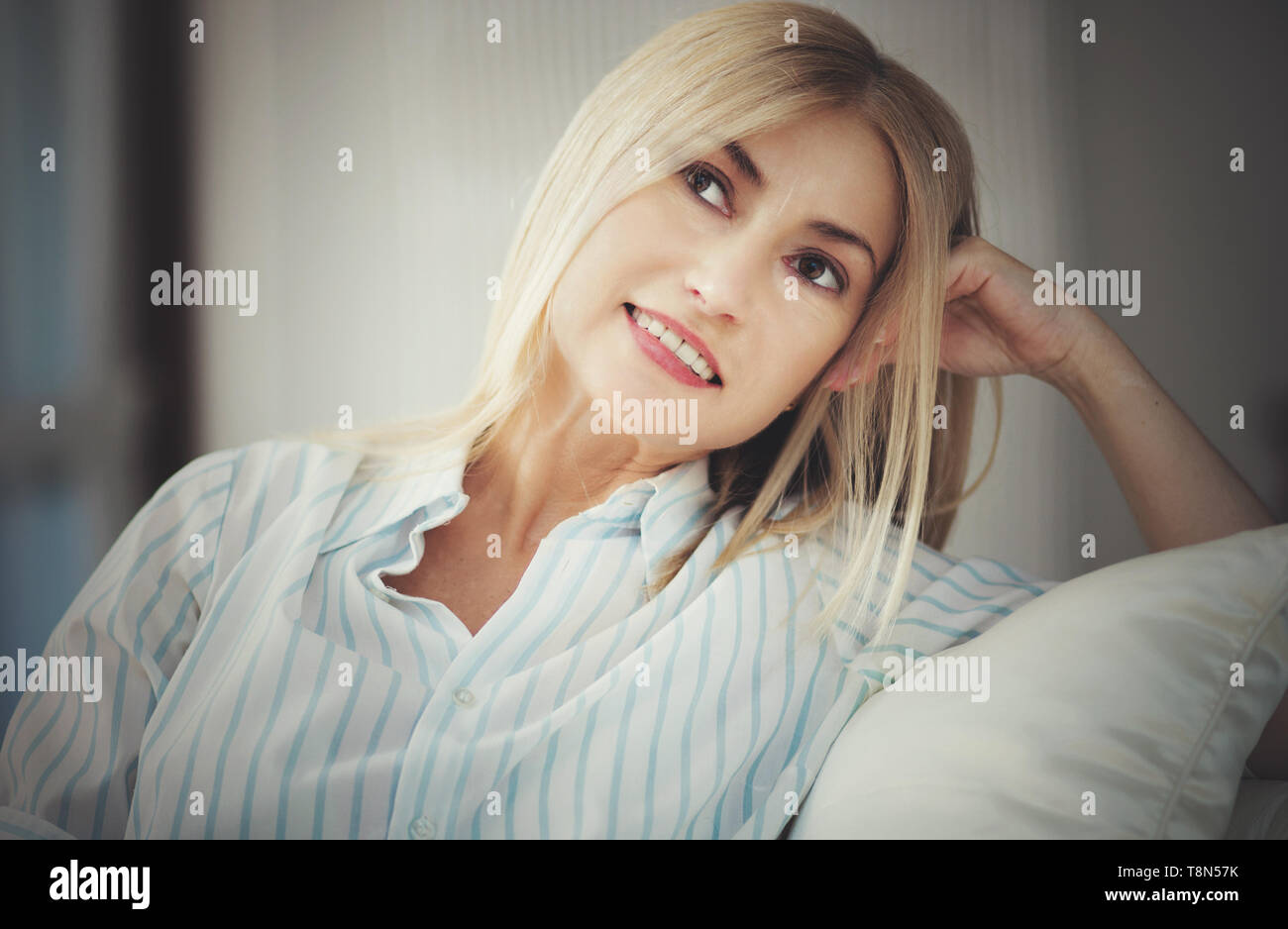 Mature woman lying on couch hi-res stock photography and images - Alamy