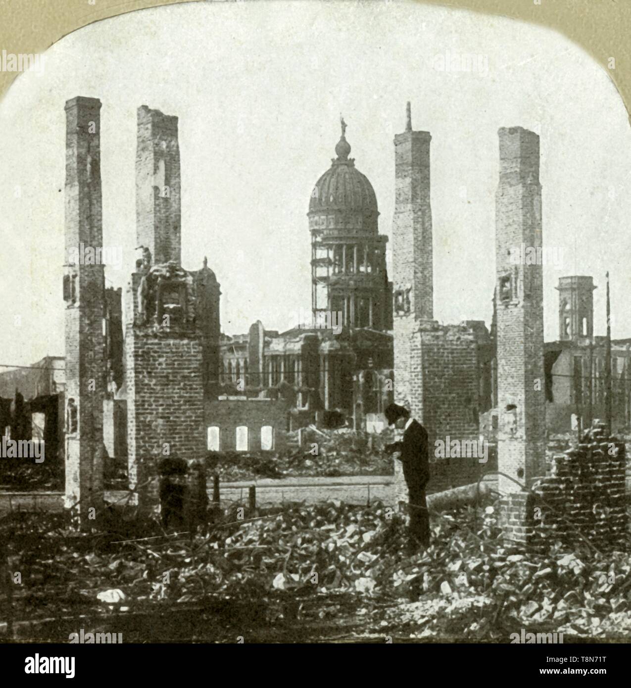 'City Hall - Photographer in foreground - Tall brick chimneys left standing', . Creator: Unknown. Stock Photo