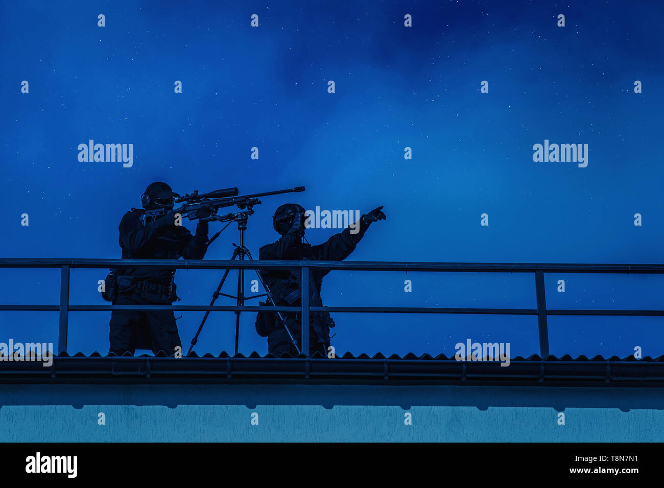 Sniper team searching target on city night mission Stock Photo