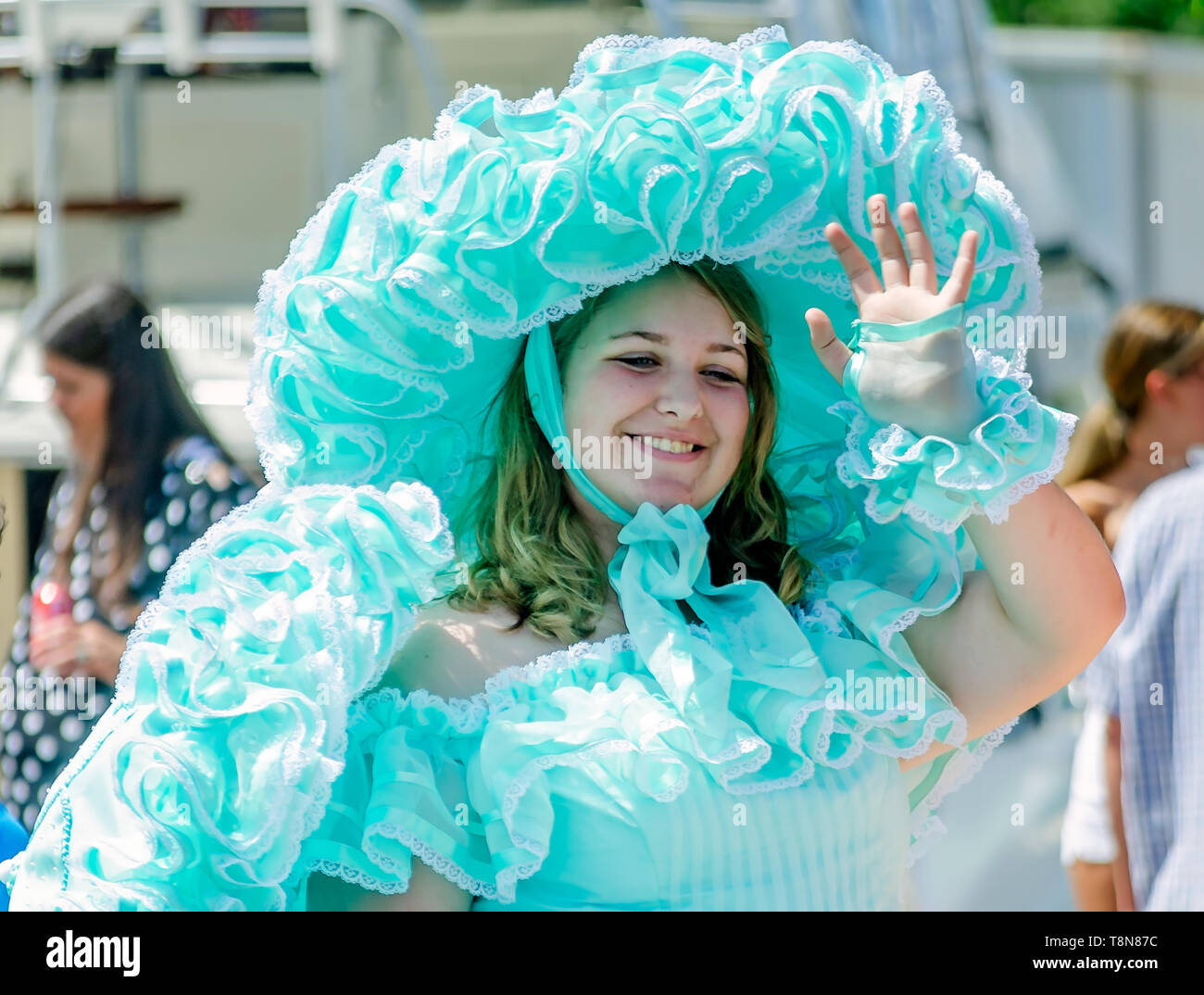 An Azalea Trail Maid waves to the crowd during the Blessing of the Fleet, May 5, 2019, in Bayou La Batre, Alabama. Stock Photo