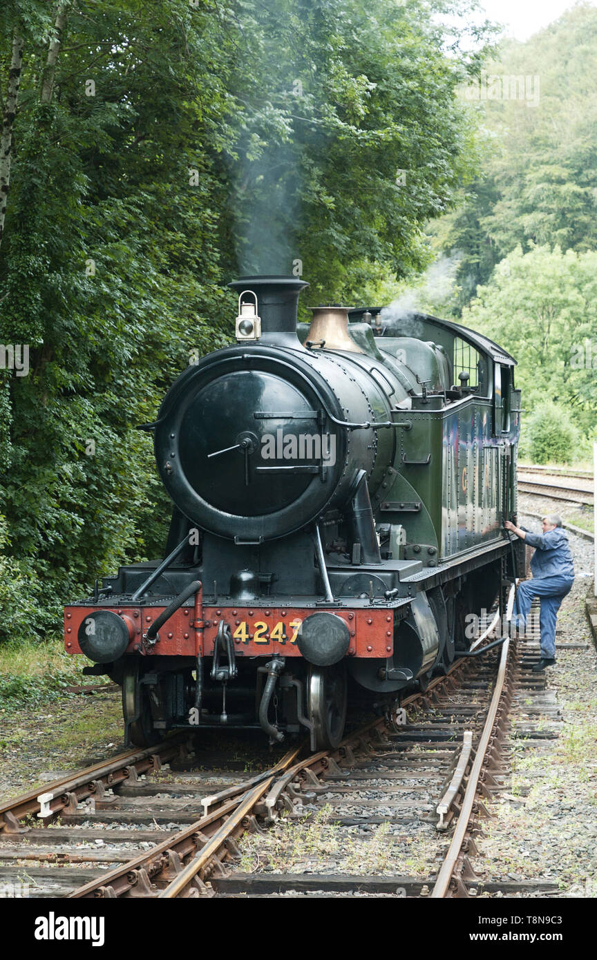 Train driver climbing into GWR class 280T 4247 train Outside Bodmin