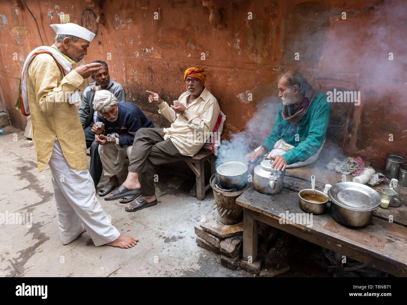 Group of men drink morning tea at a street stall in the Old City of