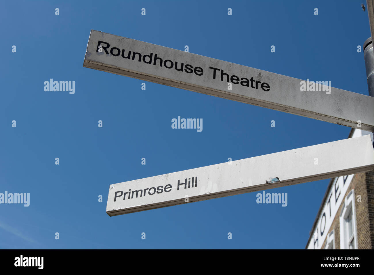 left pointing direction signs for primrose hill and the roundhouse theatre, in camden, london, england Stock Photo