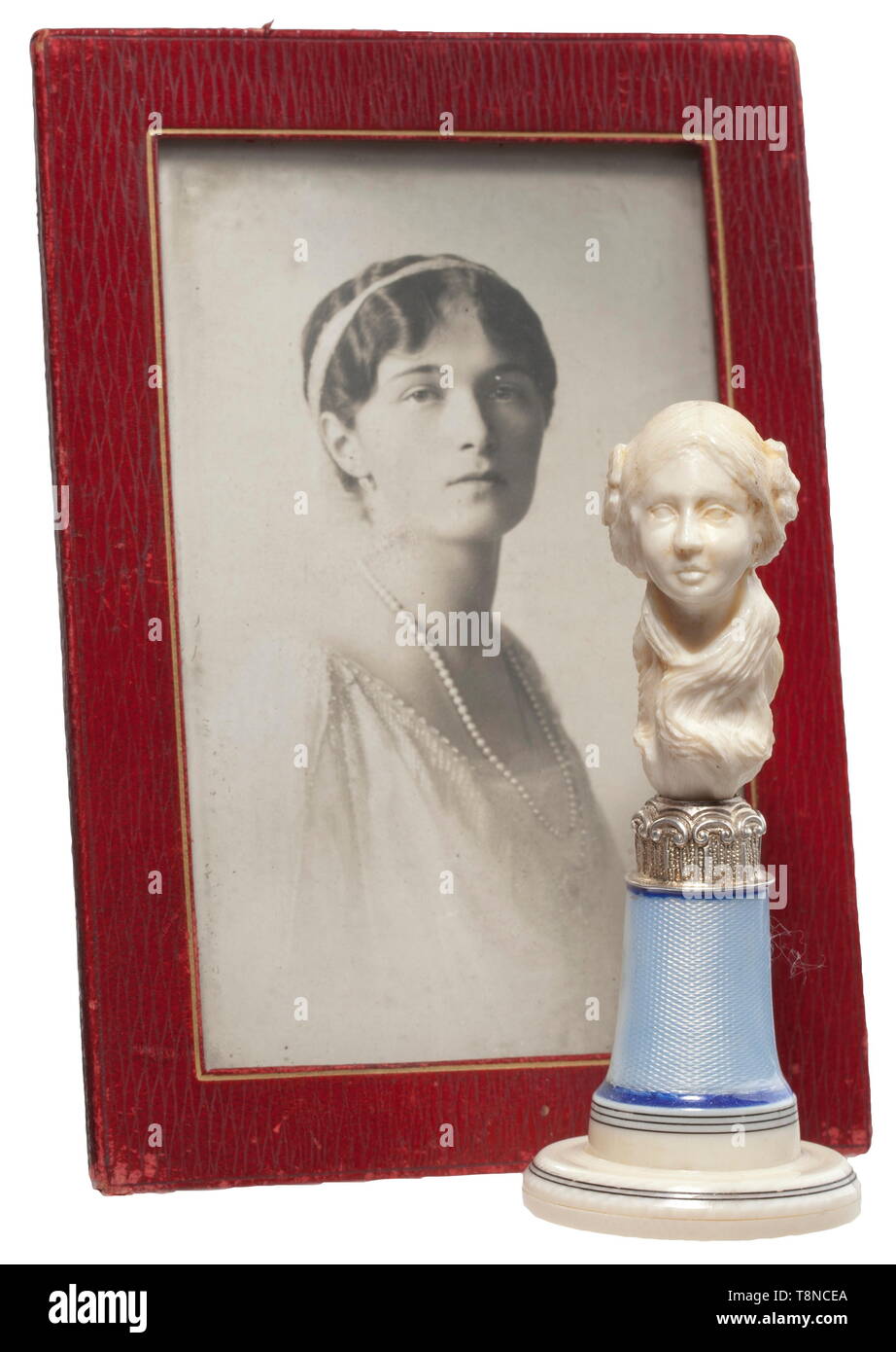Grand Duchess Olga Nikolaevna Romanova (1895 - 1918) - a personal seal Seal in the Art Nouveau style of circa 1910. Ivory, silver and translucent enamel. Finely carved bust of a young girl with her hair put up and blossoms on a silver trimmed, enamelled base, the silver seal surface cut with the crowned monogram of the grand duchess. Height 11 cm. Also a framed photo at the age of about 18 years, a red leather frame with the portraits of Olga, Anastasia and the heir apparent Alexej Nikolaevitch, as well as various picture postcards, two clippings, Additional-Rights-Clearance-Info-Not-Available Stock Photo
