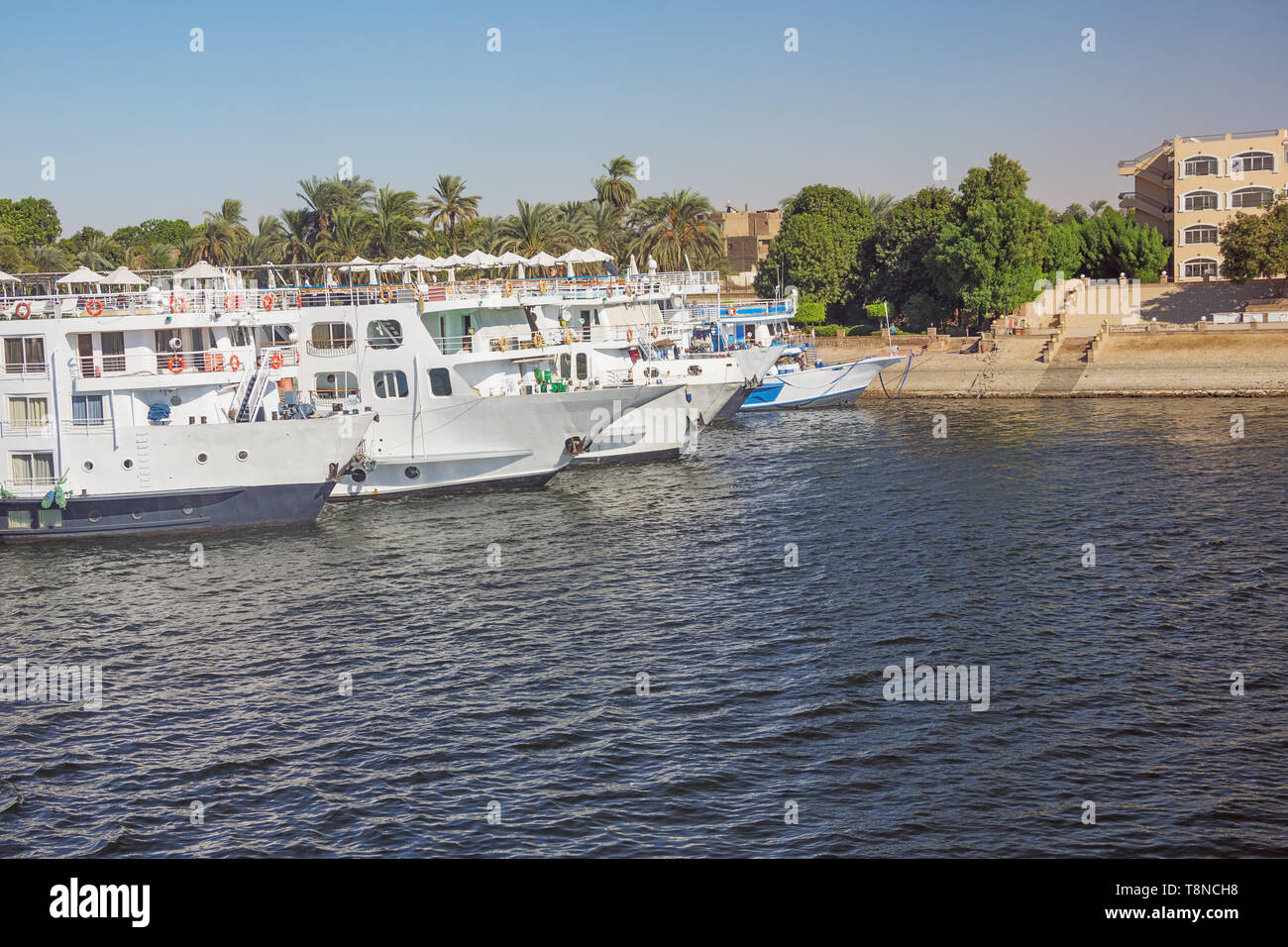Nile cruise ships moored at the quay, in the vicinity of Luxor Stock Photo