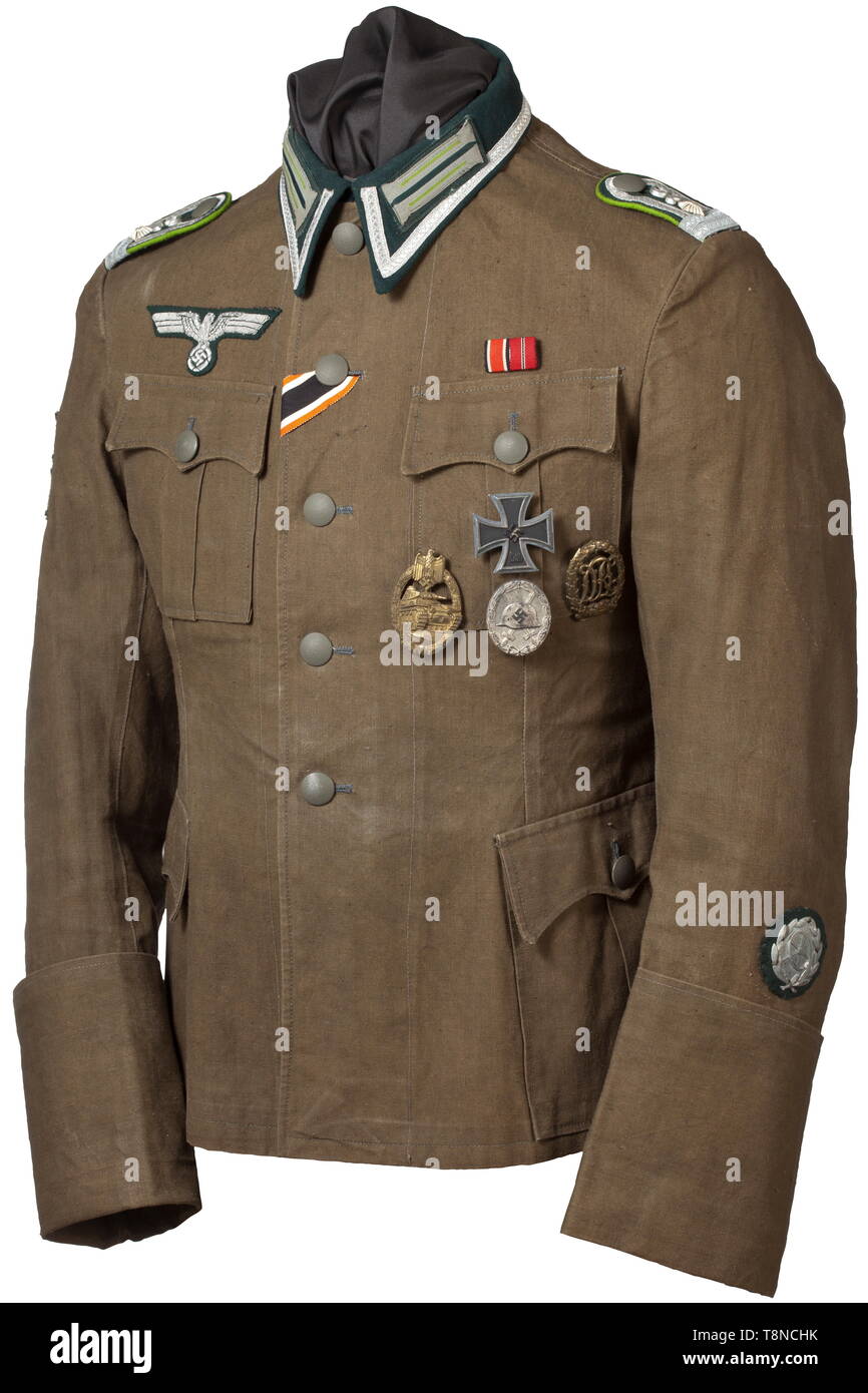 A light field tunic (southern front) for an ensign of the Panzergrenadiere with applied orders and two special badges Dark green wool cloth, four applied pockets, sewn-on hand-embroidered national eagle in officer's version. Sewn shoulder boards with applied 'L' for 'Lehrabteilung' (training detachment) with meadow green piping and interweaves, same as the unit collar patches. Affixed to the jacket are an Iron Cross 1st Class of 1939 by maker '20' for Zimmermann in Pforzheim, a Panzer Assault Badge in Bronze in half-hollow issue, a Wound Badge in Silver by maker '127', a DR, Editorial-Use-Only Stock Photo