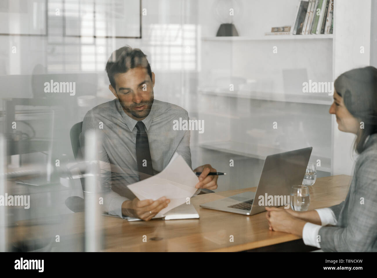 Content manager reading an applicant's resume during an interview Stock Photo