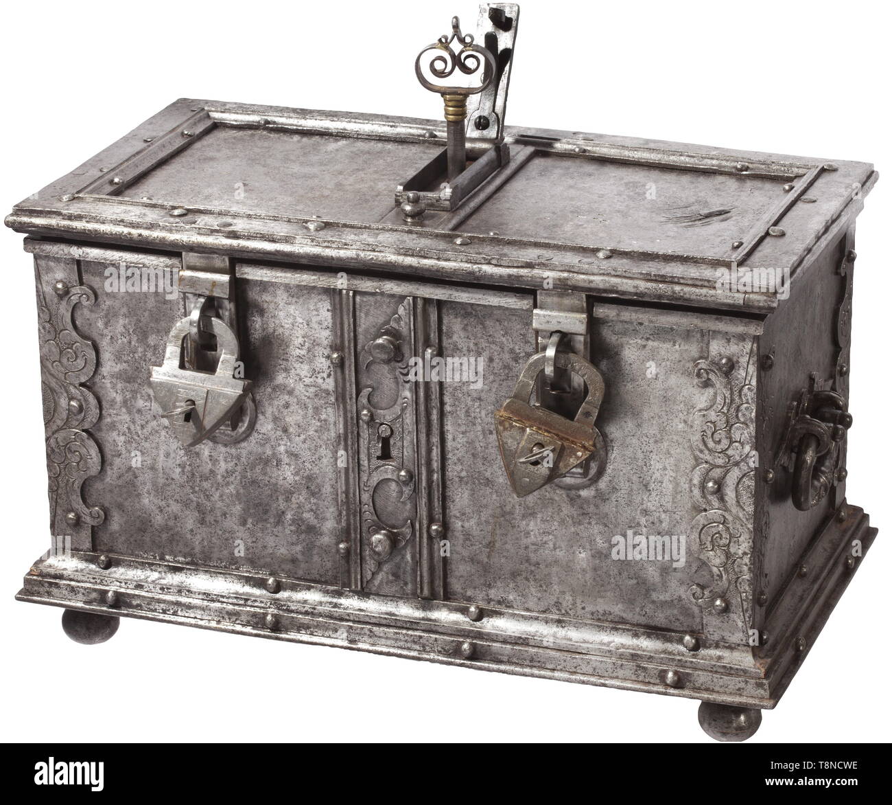A heavy Southern German iron casket, presumably Nuremberg, circa 1620 Rectangular sheet iron body, reinforced edges with engraved and embossed decoration. Stepped base on four iron ball feet. False lock with curved escutcheon at the front, two hasps (partially replaced) with attached triangular locks (each one marked). The hinged lid with heavily reinforced edges. The cover of the central keyhole with hidden locking and spring-loaded lid. The inside with elaborate locking mechanism with tenfold locking. Replaced hollow shank key. Lavish openwork , Additional-Rights-Clearance-Info-Not-Available Stock Photo