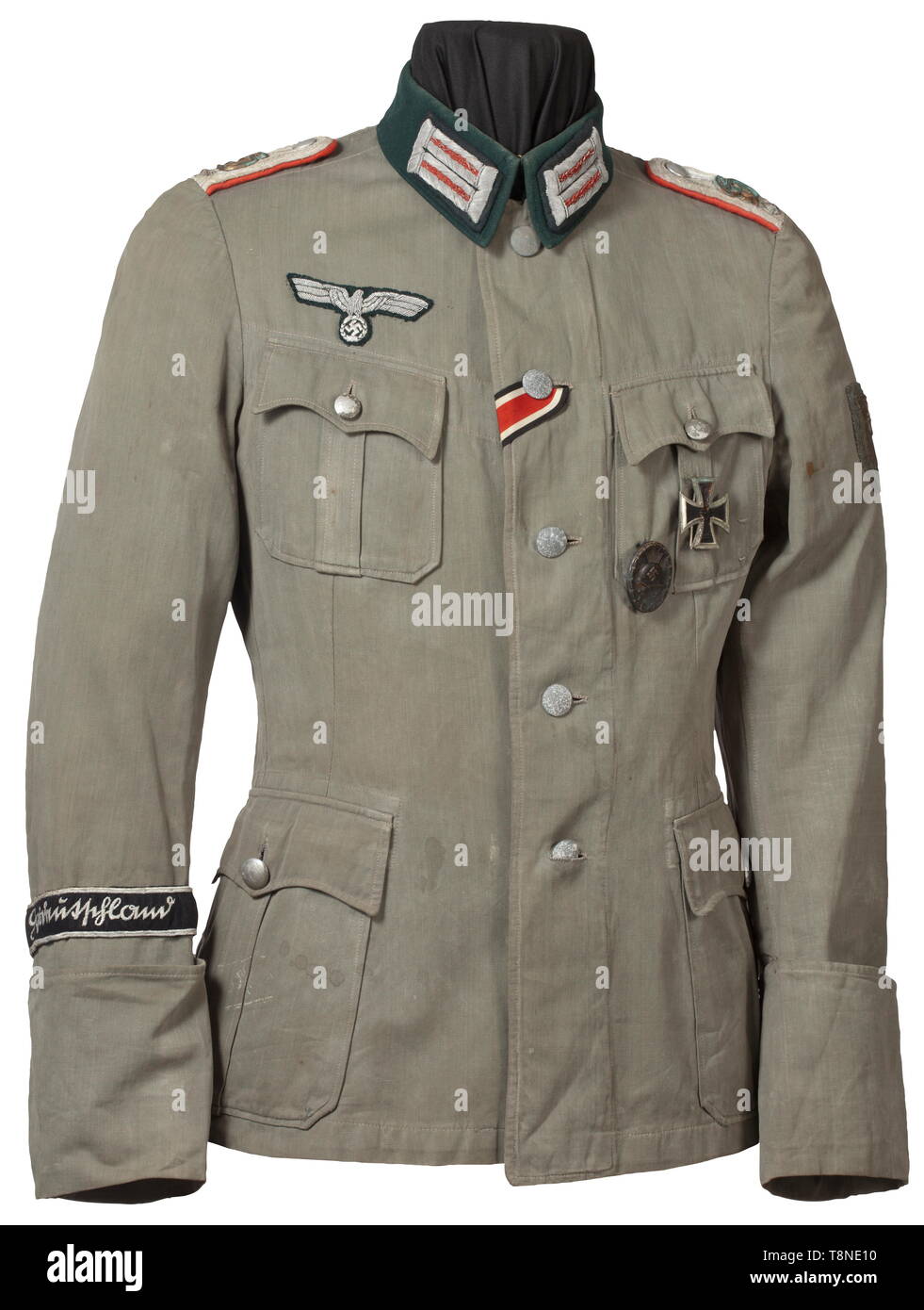 A field tunic for an Oberleutnant in Artillery Regiment 'Großdeutschland' Summer coat of field grey linen, in unlined issue with dark green collar and insignia for an officer. The shoulder boards with gold 'GD' appliqués, the cuff title in black velveteen with silver edge braid and silver-embroidered inscription 'Großdeutschland' in Sütterlin script. Stitched-on Krim Shield, affixed EK 1 and a Wound Badge in Black. An obviously used coat with storage-caused (oxidation) signs of age in never-cleaned condition. Included is the Soldbuch (Paybook) wi, Additional-Rights-Clearance-Info-Not-Available Stock Photo
