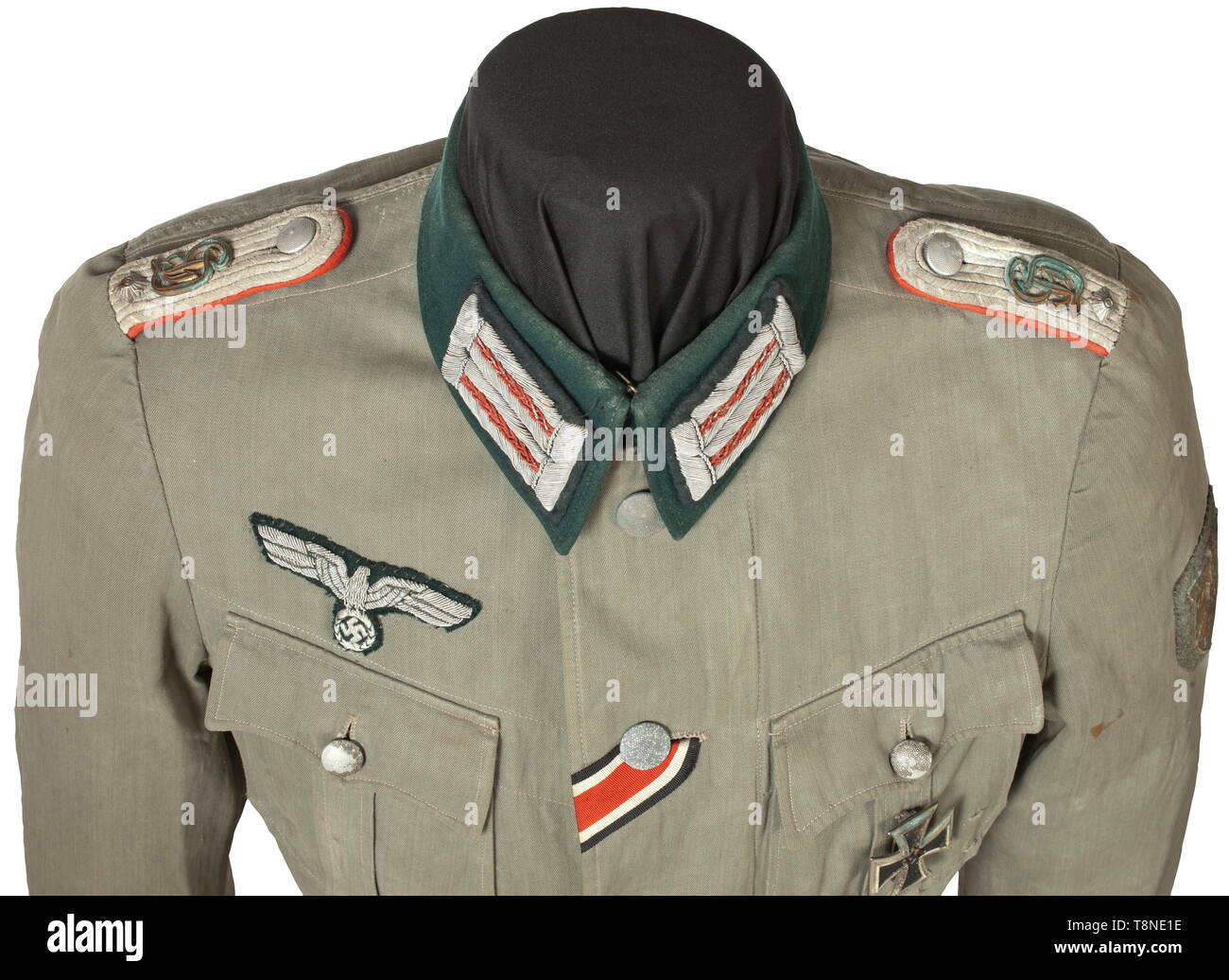 A field tunic for an Oberleutnant in Artillery Regiment 'Großdeutschland' Summer coat of field grey linen, in unlined issue with dark green collar and insignia for an officer. The shoulder boards with gold 'GD' appliqués, the cuff title in black velveteen with silver edge braid and silver-embroidered inscription 'Großdeutschland' in Sütterlin script. Stitched-on Krim Shield, affixed EK 1 and a Wound Badge in Black. An obviously used coat with storage-caused (oxidation) signs of age in never-cleaned condition. Included is the Soldbuch (Paybook) wi, Additional-Rights-Clearance-Info-Not-Available Stock Photo