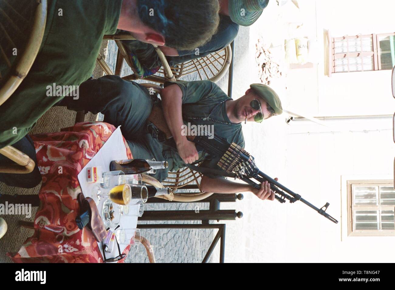 A Croatian soldier poses with a heavy machine gun at a cafe in the Croatian capital Zagreb in the former Yugoslavia during the conflict there in 1991-92. Picture by Adam Alexander Stock Photo
