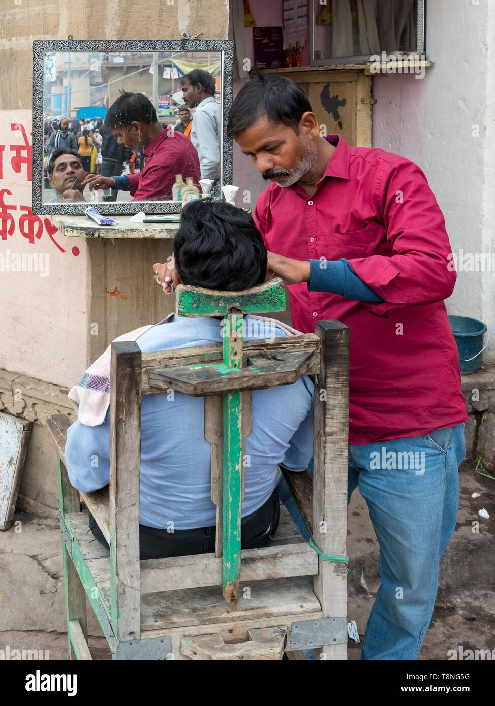 Outdoor barber shop on the ghats of the River Ganges, Varanasi, India
