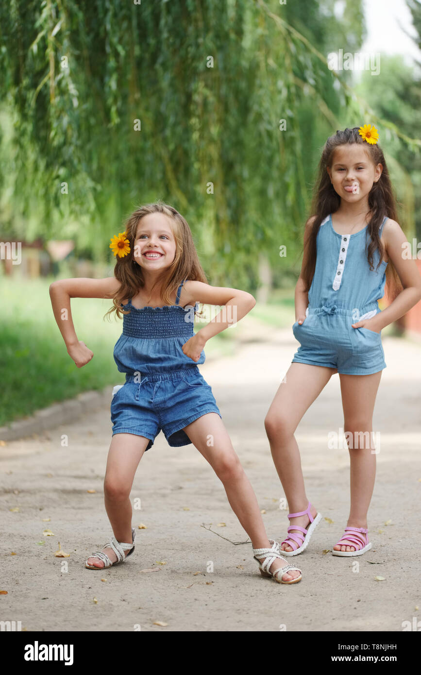 photo of two little girls in summer park Stock Photo - Alamy