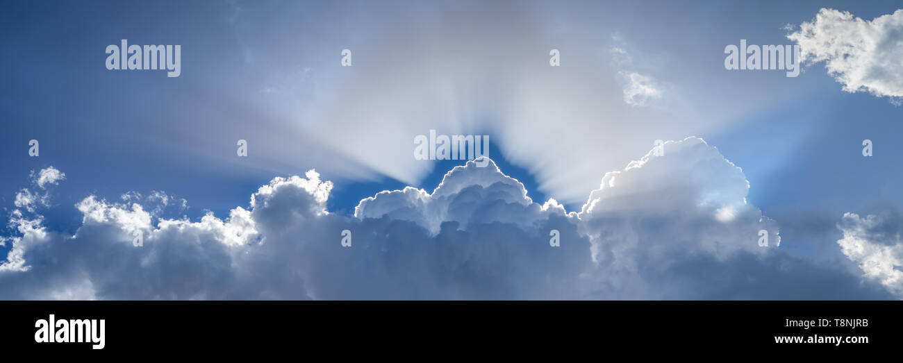 Sun through puffy clouds hi-res stock photography and images - Alamy