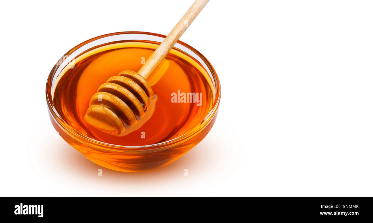 Honey stick and bowl of honey isolated on white background with