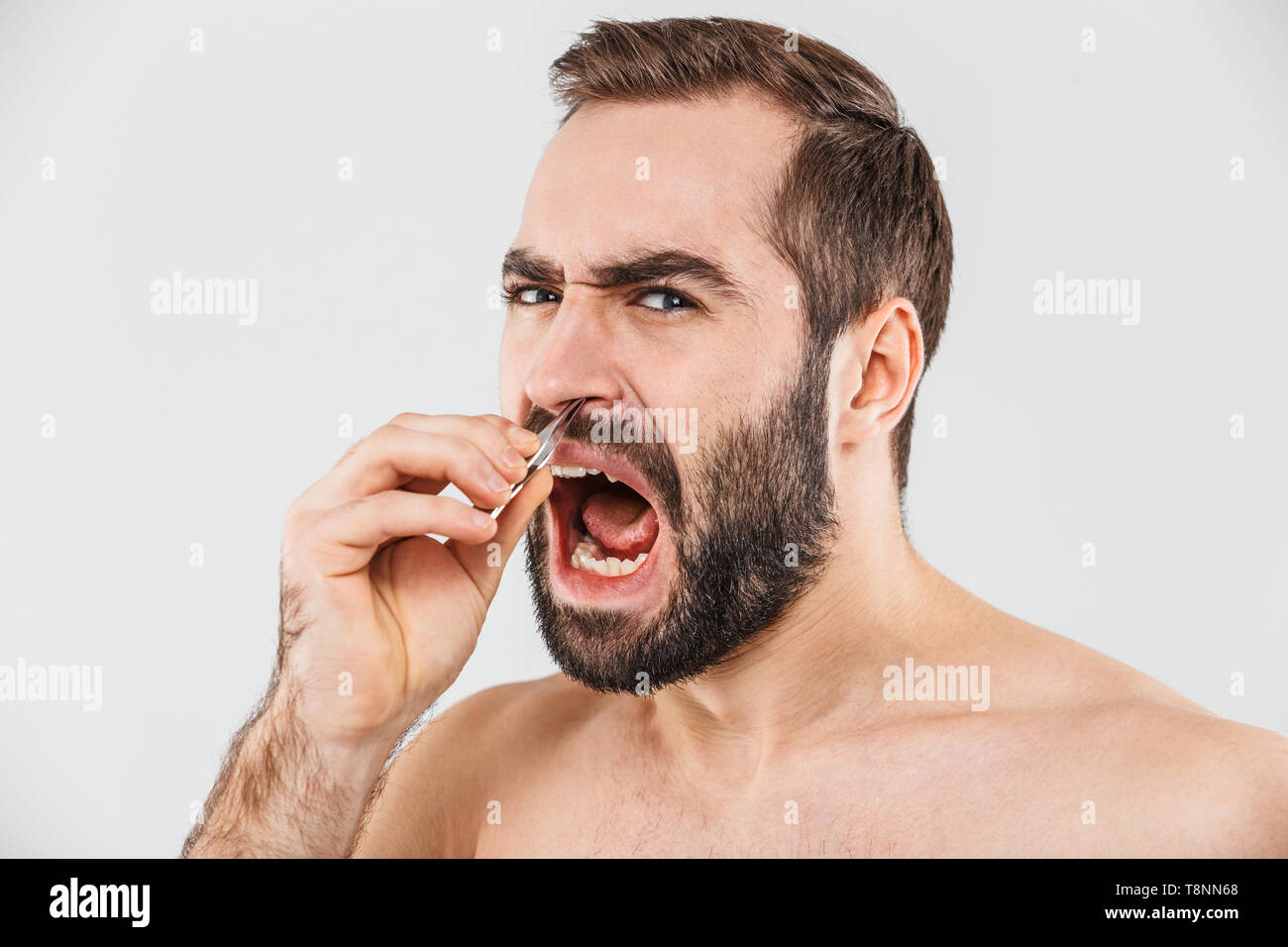 Close up portrait of a suffering bearded man standing isolated over ...