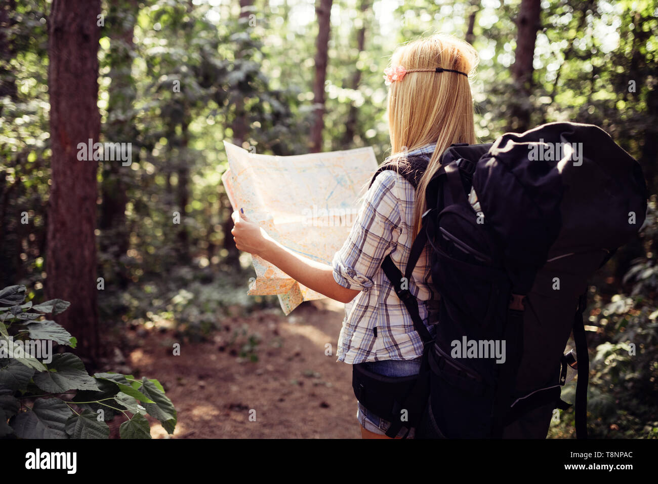 Hipster tourist woman with map hiking, lifestyle adventure concept Stock Photo