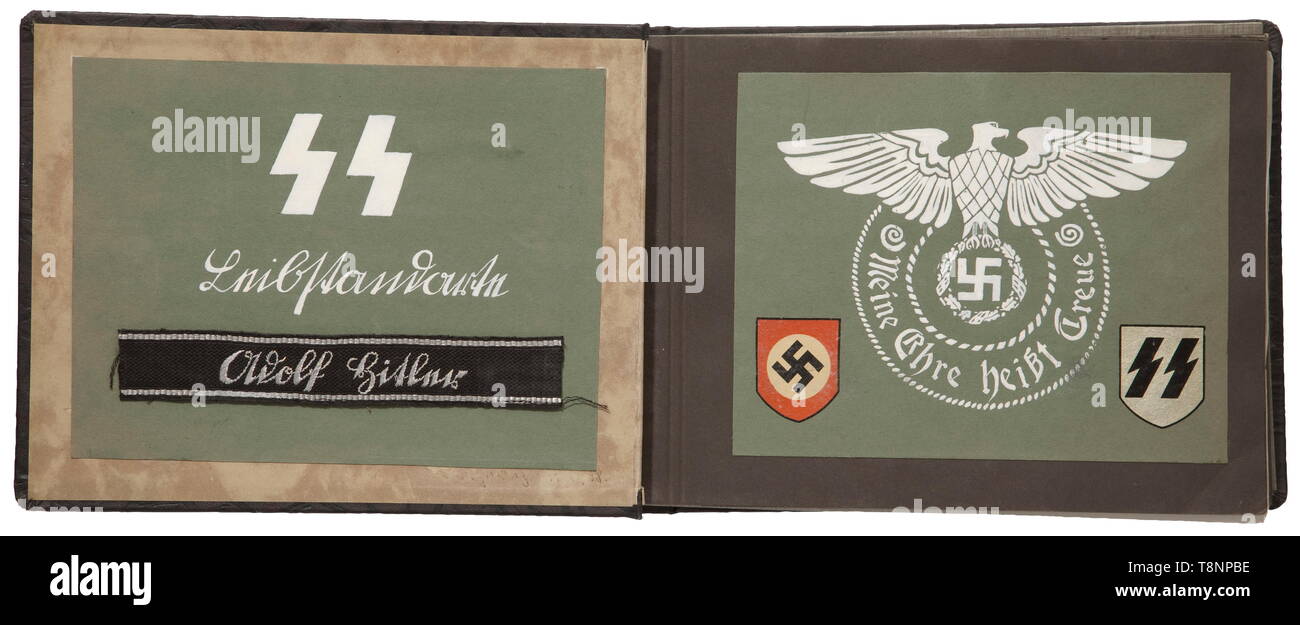 A photo album of a member of the Division Leibstandarte SS Adolf Hitler Brown cover with steel helmet appliqué, circa 105 glue-affixed images, some with inscriptions. Within the album a shortened 'Adolf Hitler' cuff title, hand-embroidered issue for leaders, length 17 cm, two steel helmet decals of the Waffen-SS, both sides decorated with SS-runes and the Waffen-SS-motto 'Meine Ehre heißt Treue'. Images include swearing-in, military training area Döberitz, postcards of the Berlin Lichterfelde barracks, daily duties, Adolf Hitler strides along the frontline, French campaign,, Editorial-Use-Only Stock Photo