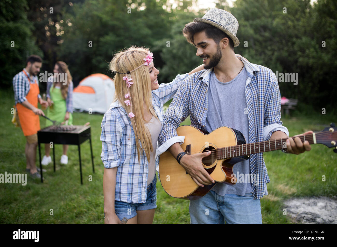 Group of happy friends having barbecue party in forest Stock Photo - Alamy