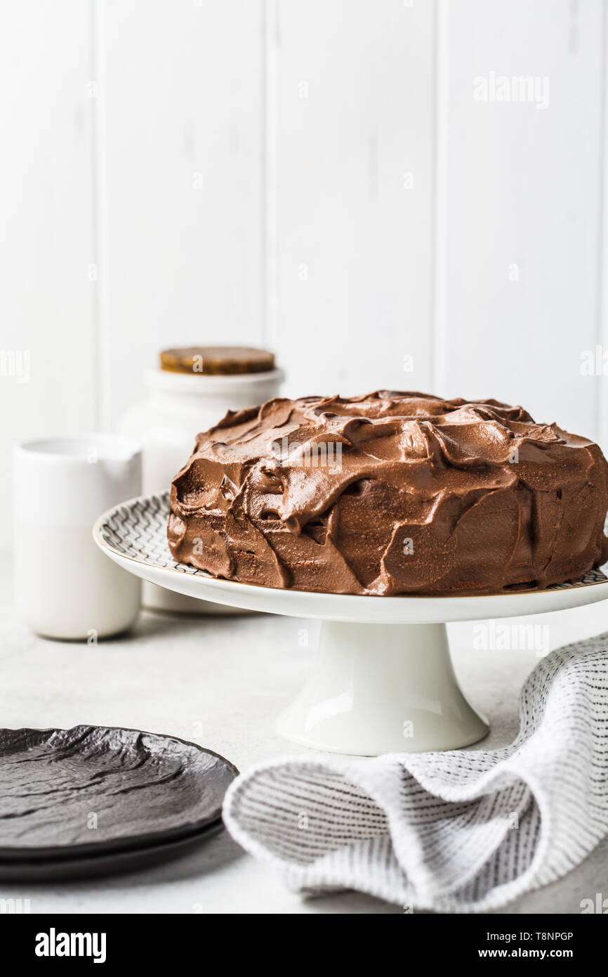Homemade whole chocolate cake with chocolate cream on a cake plate ...
