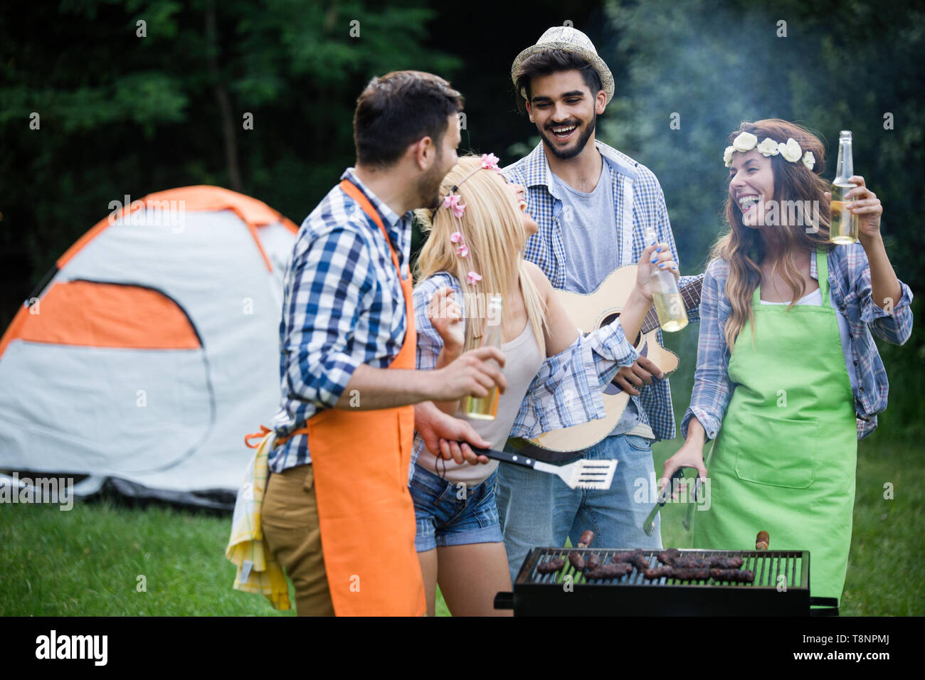 Group of happy friends having barbecue party in forest Stock Photo - Alamy