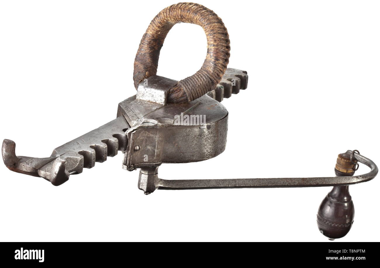 A cranequin, Nuremberg, dated 1565 Made of iron. Angular gearbox with a brass-lined master's mark (stag and hunting horn with the initials 'FS'). Original shaft loop made of knotted hemp cords. Curved crank arm with the original turned wooden handle with a bone ferrule. The gear rack with bowstring claw and finely engraved date 1565, the belt hook is missing. Length 34 cm. historic, historical, crossbow, crossbows, distance weapon, weapons, object, objects, clipping, cut out, cut-out, cut-outs, 16th century, Additional-Rights-Clearance-Info-Not-Available Stock Photo