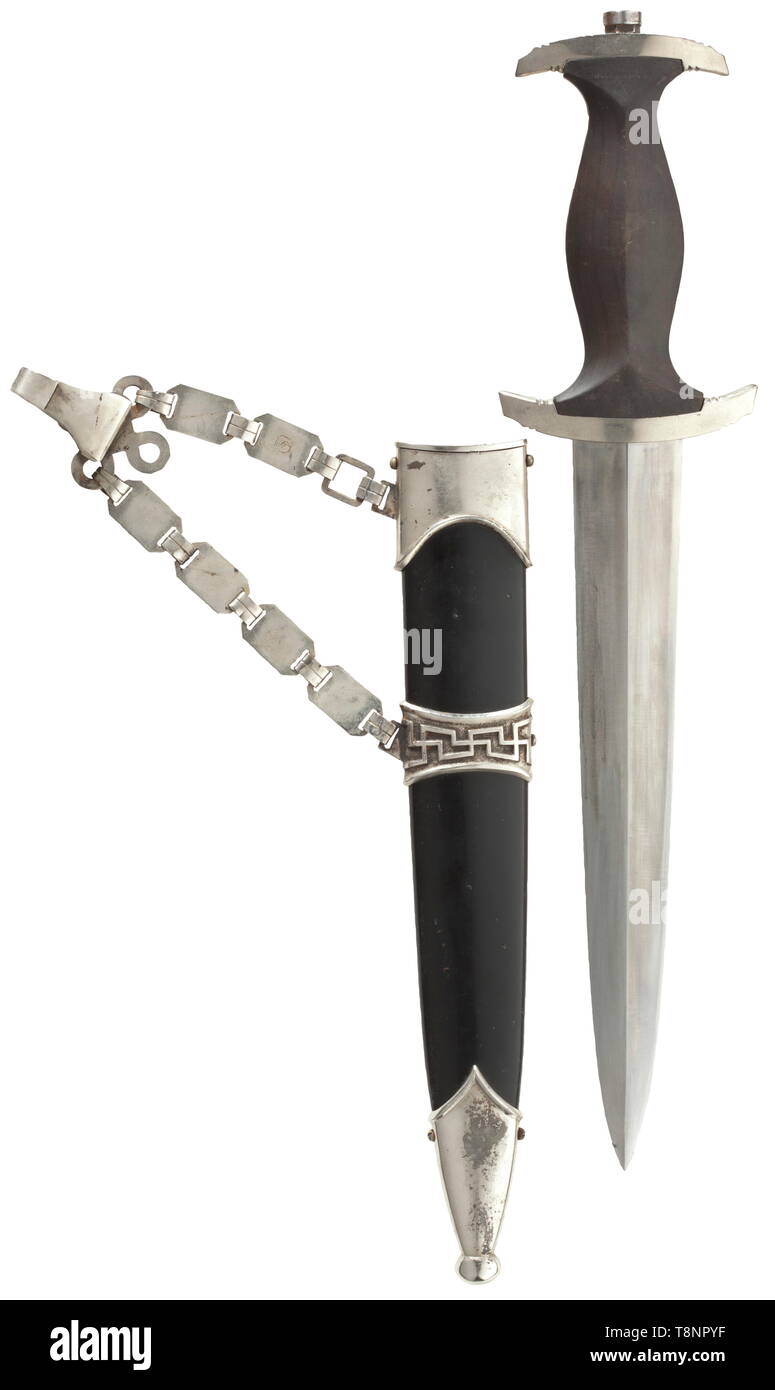 An SS service dagger M 36 for leaders The blade with etched motto. Silvered guard fittings, black wooden grip with inset National Eagle and enameled SS emblem. Black lacquered steel scabbard with nickel-plated fiitings. Iron chain hanger with mostly intact nickel plating and reverse SS stamping. Length 37 cm. historic, historical, 20th century, 1930s, 1940s, Waffen-SS, armed division of the SS, armed service, armed services, NS, National Socialism, Nazism, Third Reich, German Reich, Germany, military, militaria, utensil, piece of equipment, utensils, object, objects, stills, Editorial-Use-Only Stock Photo