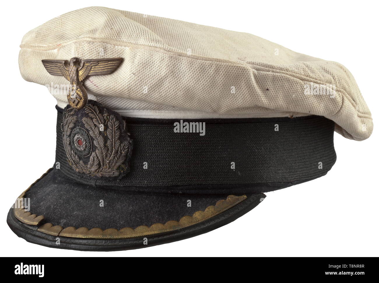 A visor cap for a U-boat commander Removable cover of white waffled piqué (soiled), a black mohair band, the visor with a golden wreath of stamped sheet brass (broken) for the rank group of subaltern officers. A gold-embroidered oak leaf wreath (darkened) and a gilded metal eagle with the manufacturer's mark. Front peak loose or re-stitched. Yellow silk liner with cap trapezoid, brown leather sweatband. Extremely rare visor cap for commander. Obvious signs of age and wear due to sea water and usage. According to the consigner, the former wearer was awarded the German Cross , Editorial-Use-Only Stock Photo