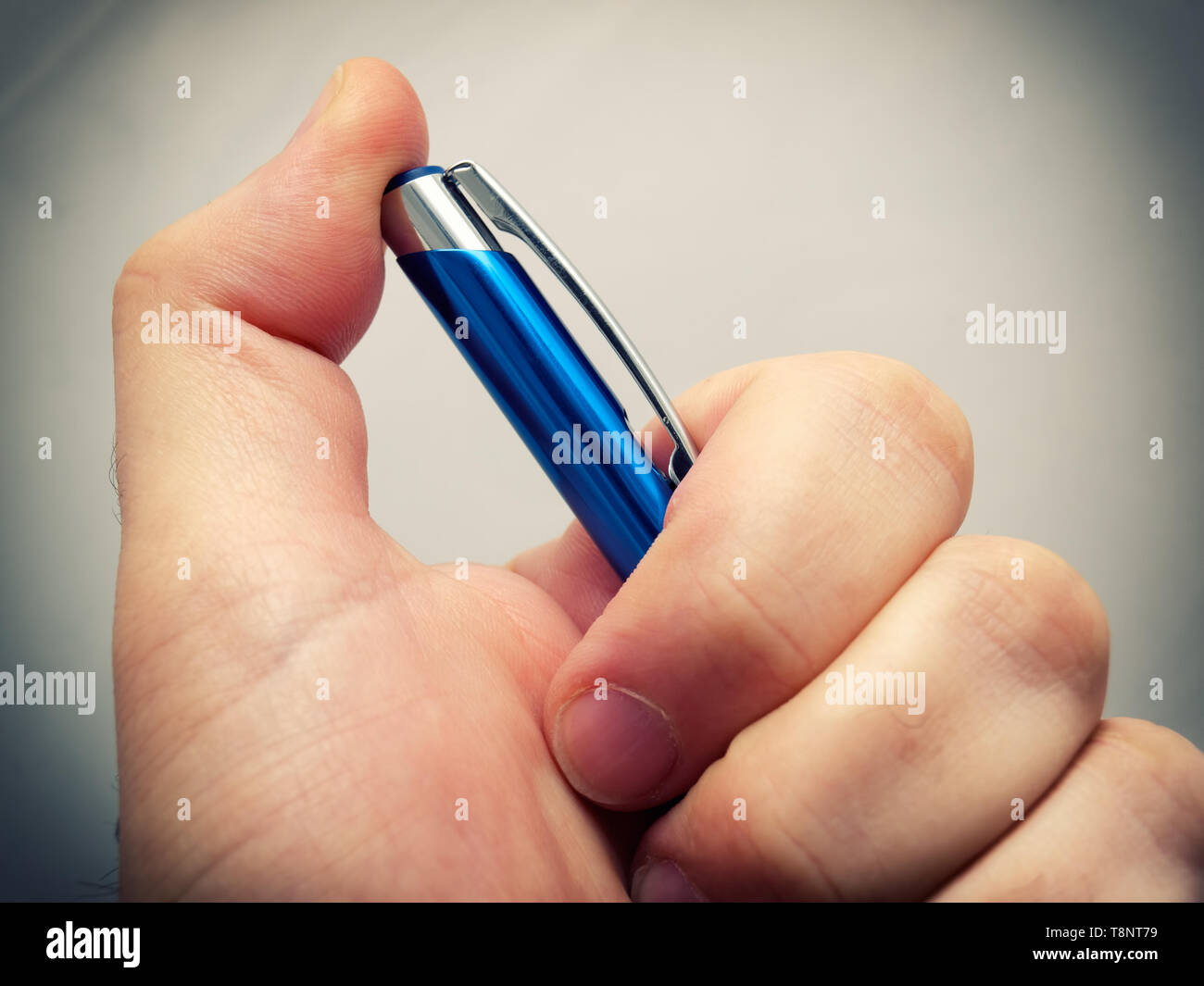 A closeup view of a hand holding a pencil. Stock Photo