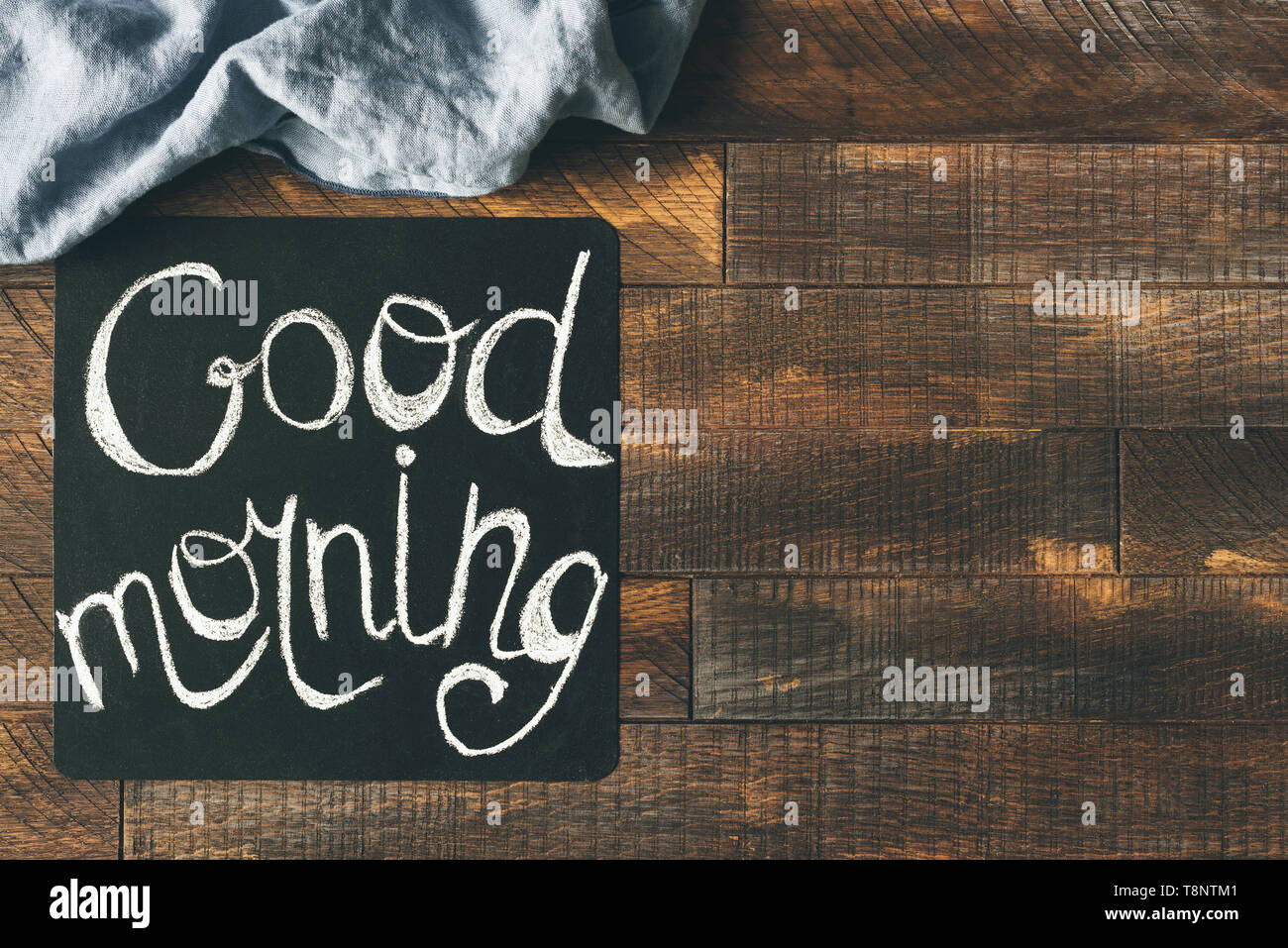 Good Morning Greeting On Blackboard On A Wooden Table Background Cheerful Morning Greeting Design Mock Up Stock Photo Alamy