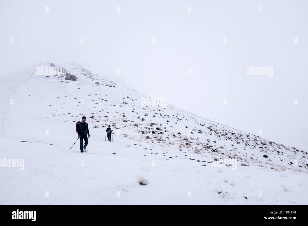 Two climbers is going to the summit in a snow mountain. Stock Photo