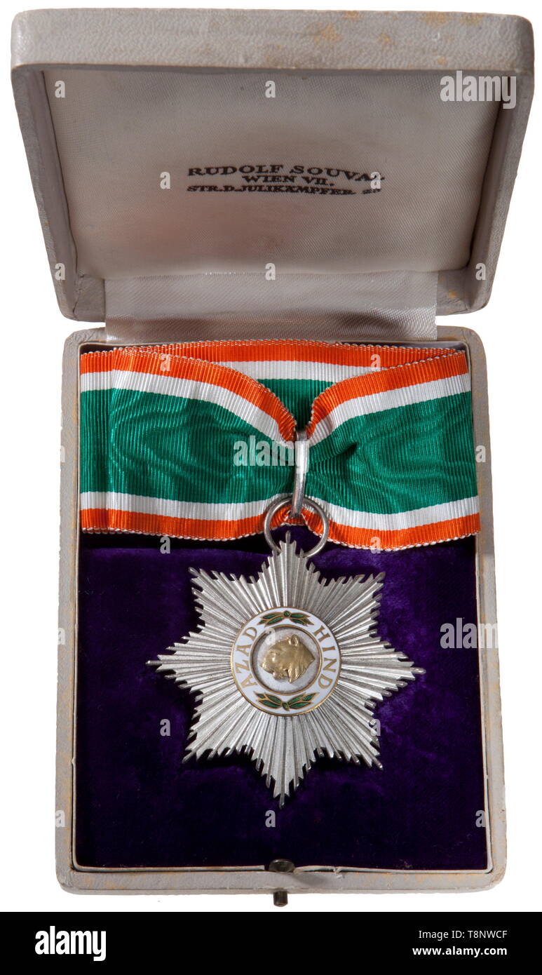 A Third Reich Azad Hind Neck Award, 1st Class, cased Eight-pointed silver starburst (60 x 60 mm) with inscription 'Azad Hind' (free India) and a lion's head enamel centre. Reverse has 'Rudolf Souval Wien VII'. Full neck ribbon having tie ends. Complete with white leatherette fitted box (9 x 12 cm) with push button release. Satin lid with printed 'Rudolf Souval Wien VII. Str. d. Julikämpfer 23'. USA-lot, see page 5. historic, historical, awards, award, German Reich, Third Reich, Nazi era, National Socialism, object, objects, stills, medal, decoration, medals, decorations, cl, Editorial-Use-Only Stock Photo