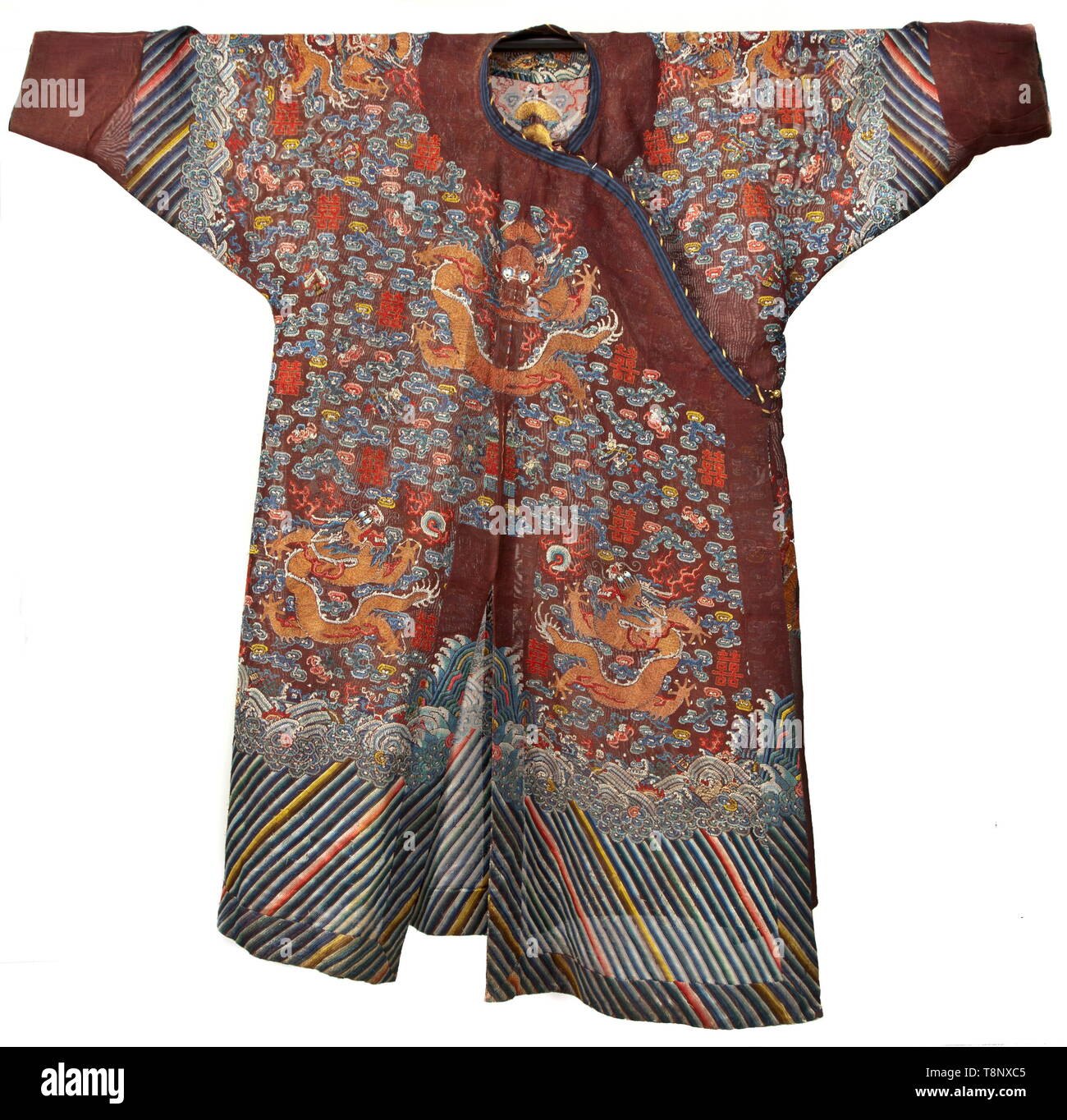A Longpao or dragon robe of a Chinese mandarin Fine, dark-red cotton fabric. Profusely embroidered and decorated with polychrome images from the Chinese culture. Among them dragons, Chinese characters (wedding symbol 'Xi'), five openwork round buttons with floral embellishments. Length of coat circa 140 cm. Extremely finely worked piece (gold and silk embroideries) from the time around 1910. According to the consignor, in 1919, Felix Count of Luckner (the 'Sea Devil') gave the coat as a wedding gift to Calixta Agnes Princess zur Lippe-Biesterfeld, Additional-Rights-Clearance-Info-Not-Available Stock Photo