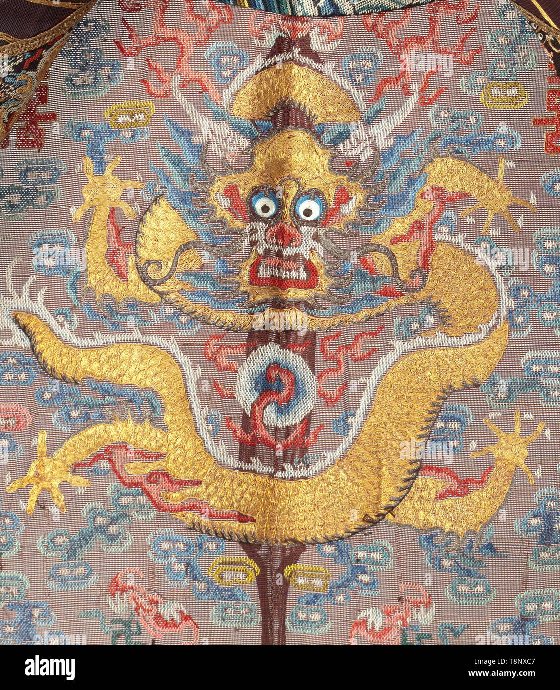 A Longpao or dragon robe of a Chinese mandarin Fine, dark-red cotton fabric. Profusely embroidered and decorated with polychrome images from the Chinese culture. Among them dragons, Chinese characters (wedding symbol 'Xi'), five openwork round buttons with floral embellishments. Length of coat circa 140 cm. Extremely finely worked piece (gold and silk embroideries) from the time around 1910. According to the consignor, in 1919, Felix Count of Luckner (the 'Sea Devil') gave the coat as a wedding gift to Calixta Agnes Princess zur Lippe-Biesterfeld, Additional-Rights-Clearance-Info-Not-Available Stock Photo