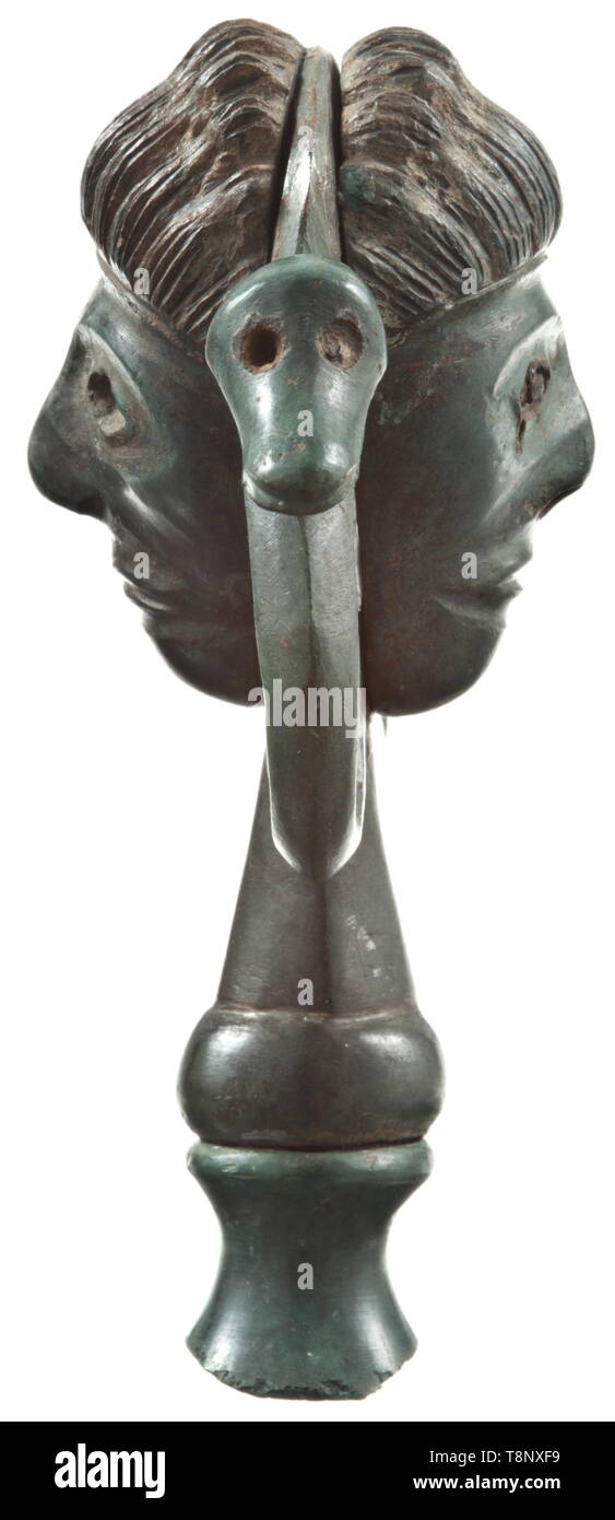 A Central European ceremonial top adornment with figurative motifs, Urnfield Period, 10th - 8th century BC Bronze ceremonial finial made of several pieces with fine emerald green patina. On both sides applied male heads with intricately worked hair. The eyes originally inlaid with organic material, presumably bone or ivory. Two lateral eyelets shaped like birds' heads. Slender finial socket made of two pieces. Height 8 cm. Superbly crafted bronze work which was probably used for cultic rites. Provenance: Private collection in Brno, in family poss, Additional-Rights-Clearance-Info-Not-Available Stock Photo