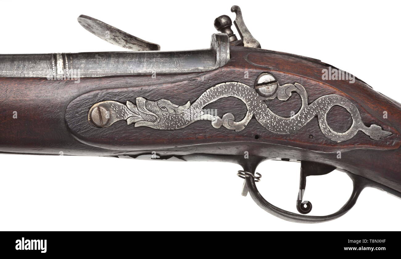A heavy German flintlock gun, circa 1720 Smooth Ottoman Damascus barrel in 21 mm calibre, near the muzzle and the powder compartment superimposed and inlaid straps made from silver as well as struck tughra and silver-filled mark. Brass front sight and aperture rear sight. Sparsely engraved flintlock. Full stock with iron furniture and horn nose. Wooden ramrod with horn tip. Length 138 cm. historic, historical, civil long guns, gun, weapons, arms, weapon, arm, 18th century, Additional-Rights-Clearance-Info-Not-Available Stock Photo