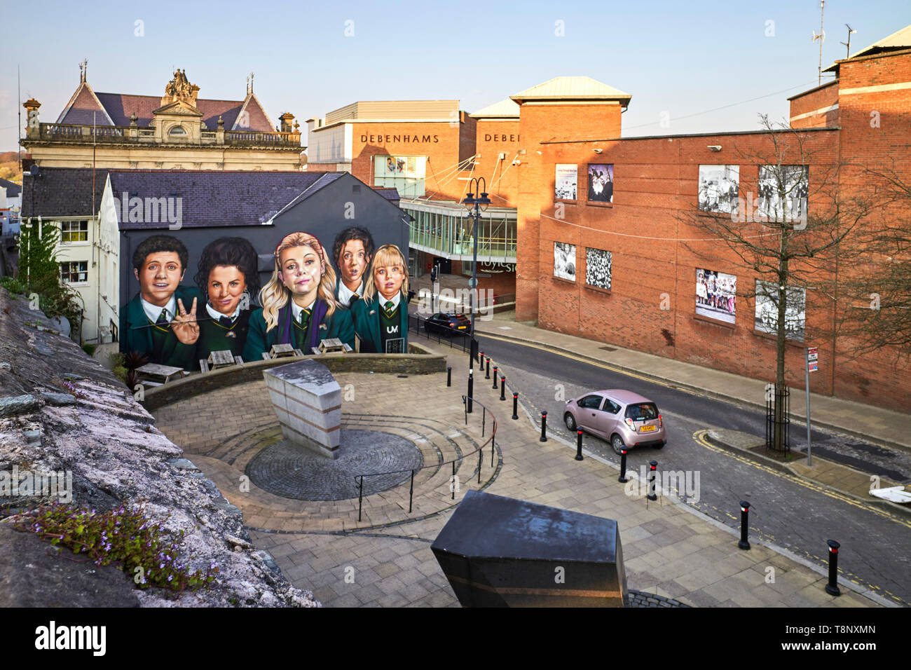 Derry Girls poster on a wall of a pub next to the Foyleside shopping centre in Londonderry, Northern Ireland Stock Photo