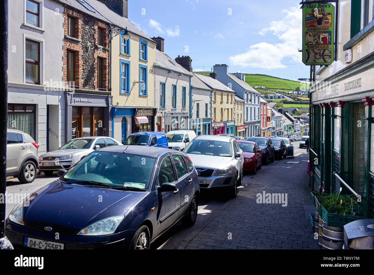 Main Street in Dingle with it’s parked cars making it feel congested Stock Photo